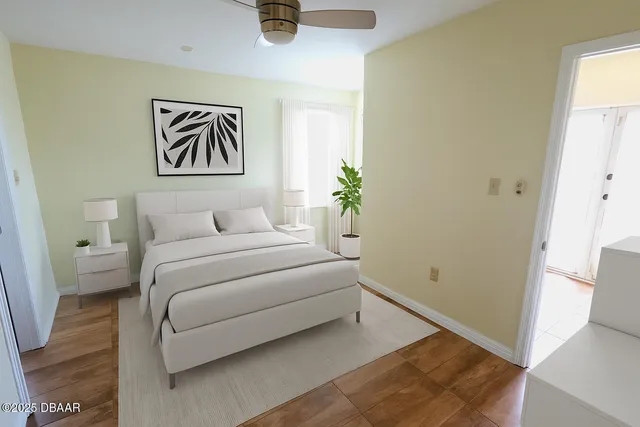 an empty room with wooden floor and a window