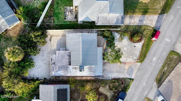 an aerial view of a house with swimming pool and garden