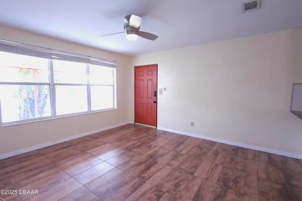 wooden floor in an empty room with a window