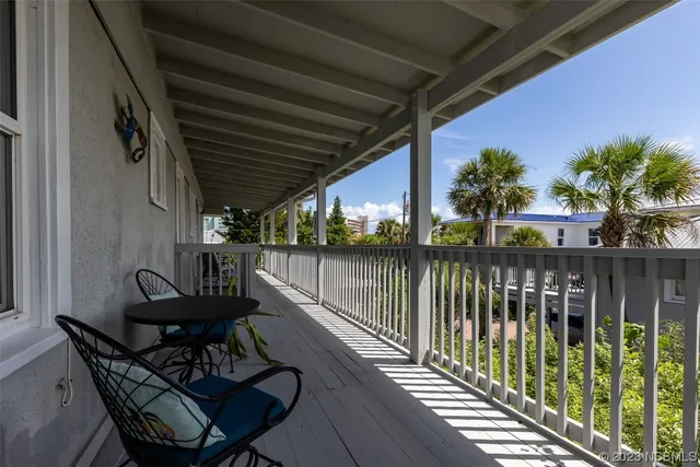 an aerial view of a house with garden space and street view