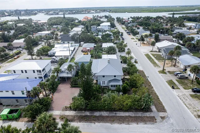 a view of a roof deck with table and chairs with wooden floor and fence