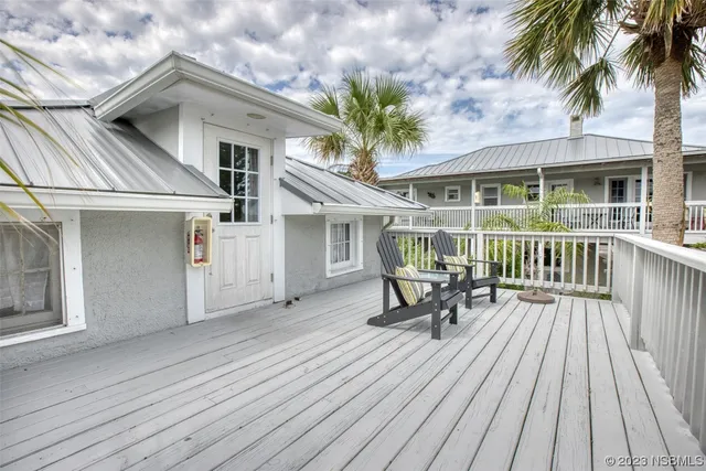 a view of a chairs and table in a balcony