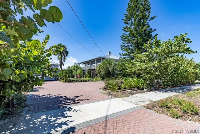 a front view of a house with lots of green space