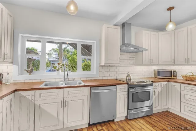 a view of a bedroom with furniture and wooden floor