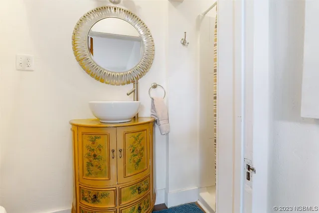 a kitchen with stainless steel appliances granite countertop a sink a stove and white cabinets