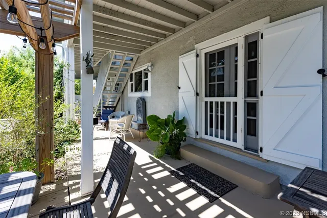 a front view of a house with a lot of flower garden