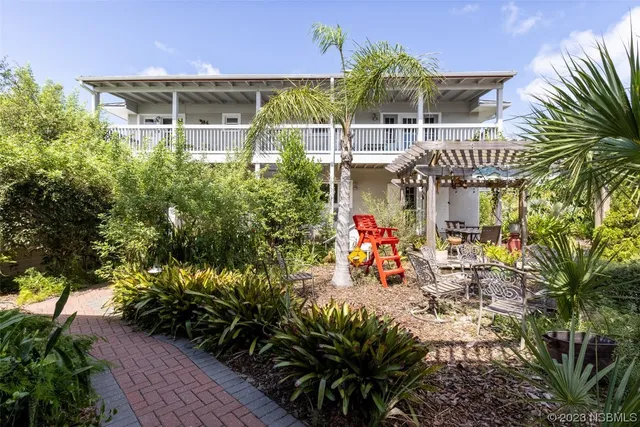 a view of a chairs and table in the balcony