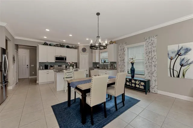 a view of kitchen with dining table and chairs