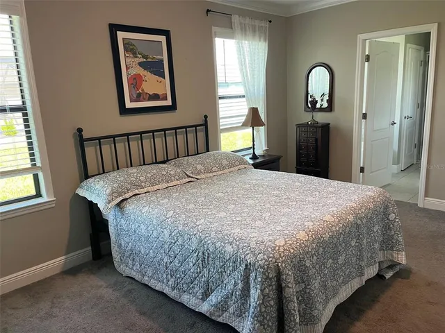 a bed sitting in a bedroom next to a window