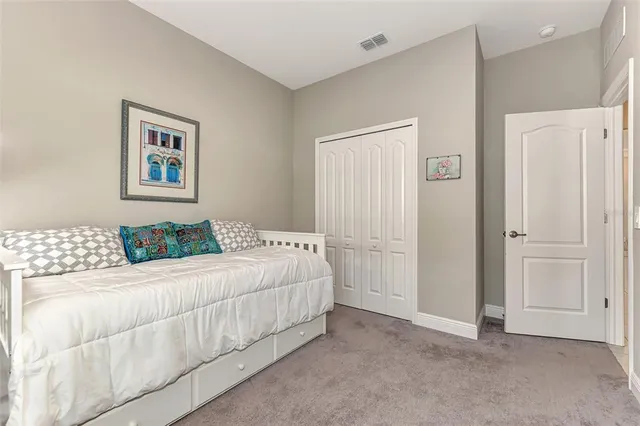 a bedroom with a bed and a white couch