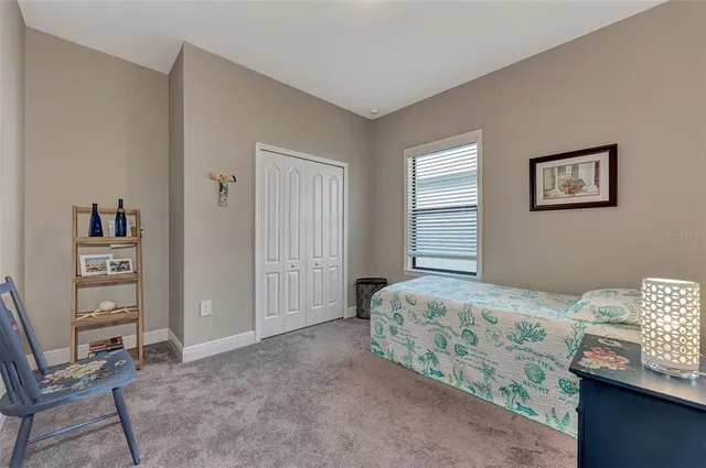 a bedroom with a bed and a chair in it