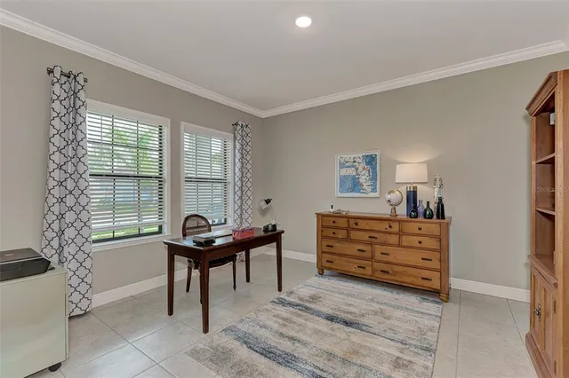 a living room with furniture and a dresser