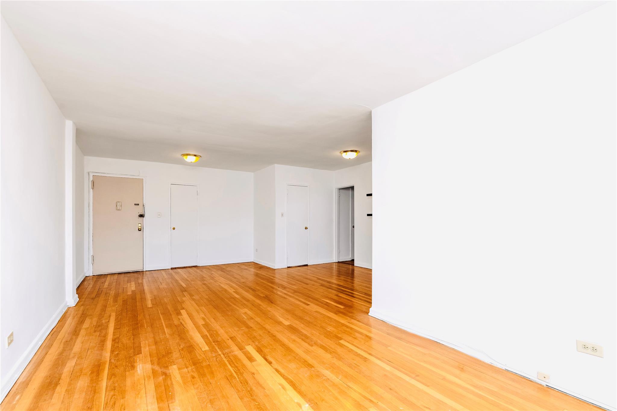 141-05 Pershing Crescent, Unit 511 Queens, NY 11435 - Photo 5 of 14 a view of a big room with wooden floor