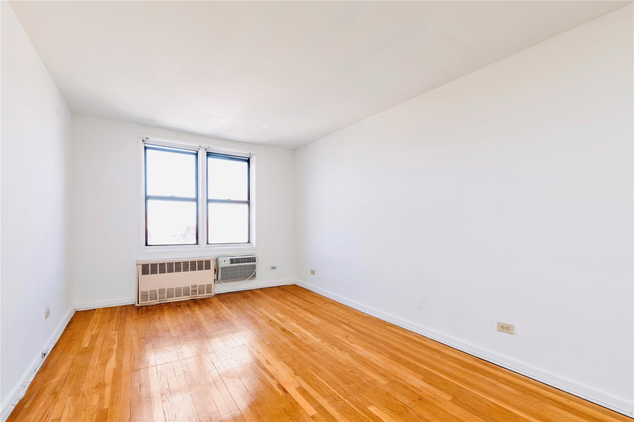 141-05 Pershing Crescent, Unit 511 Queens, NY 11435 - Photo 9 of 14 an empty room with a empty space and a window