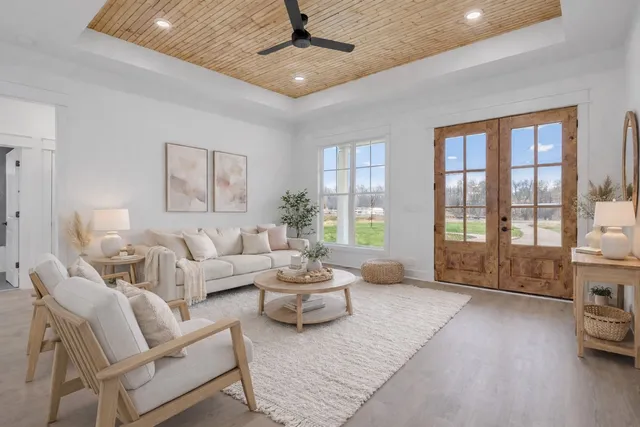 a living room with furniture and large windows