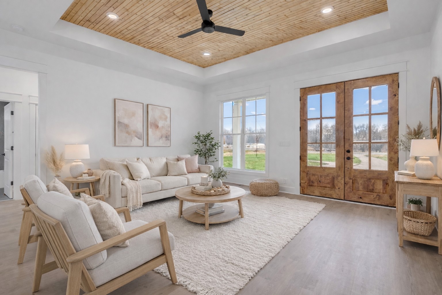 a living room with furniture and large windows