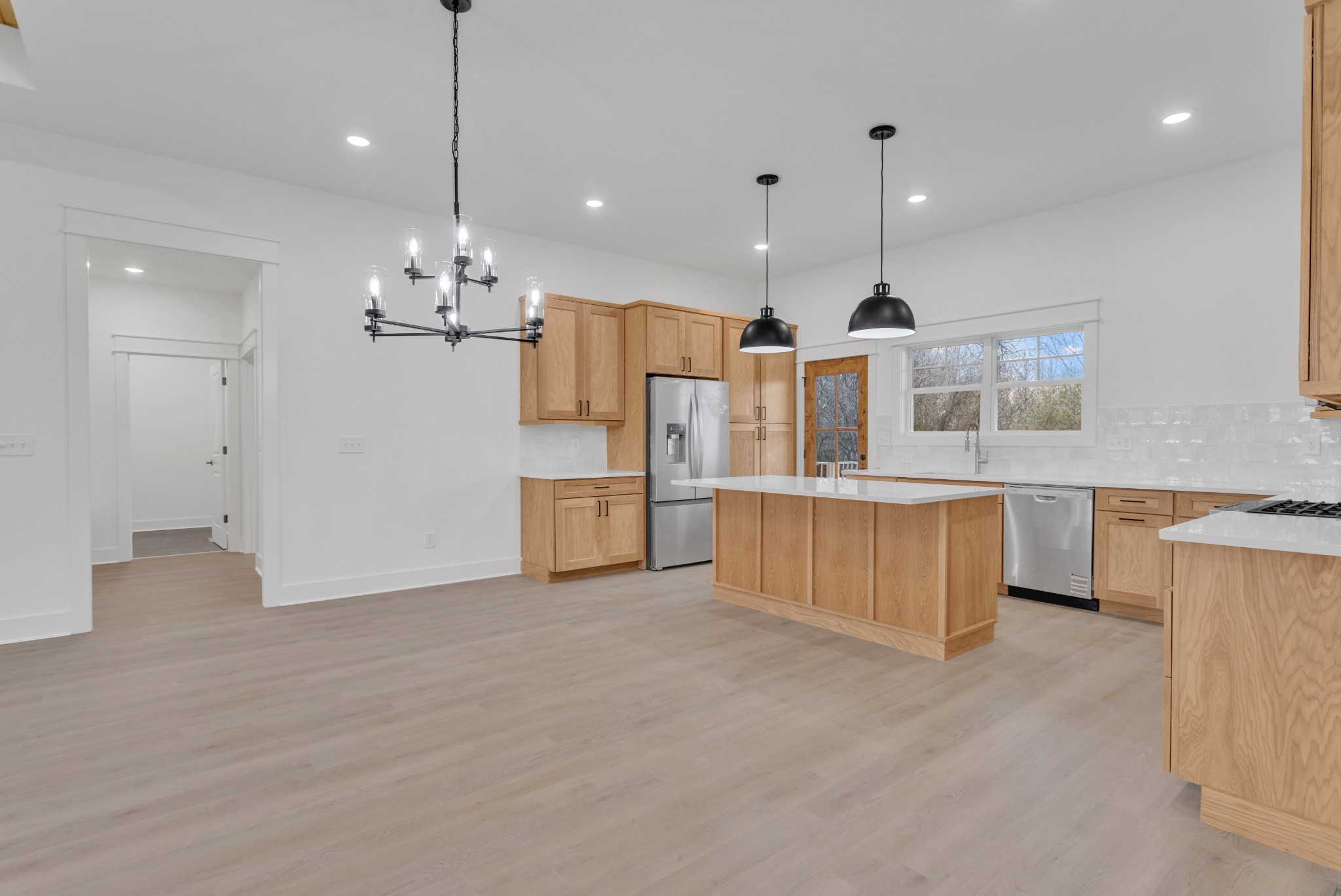 1111 Abiff Road Bon Aqua, TN 37025 - Photo 11 of 34 a large kitchen with stainless steel appliances kitchen island granite countertop a stove a sink a refrigerator and a granite counter top