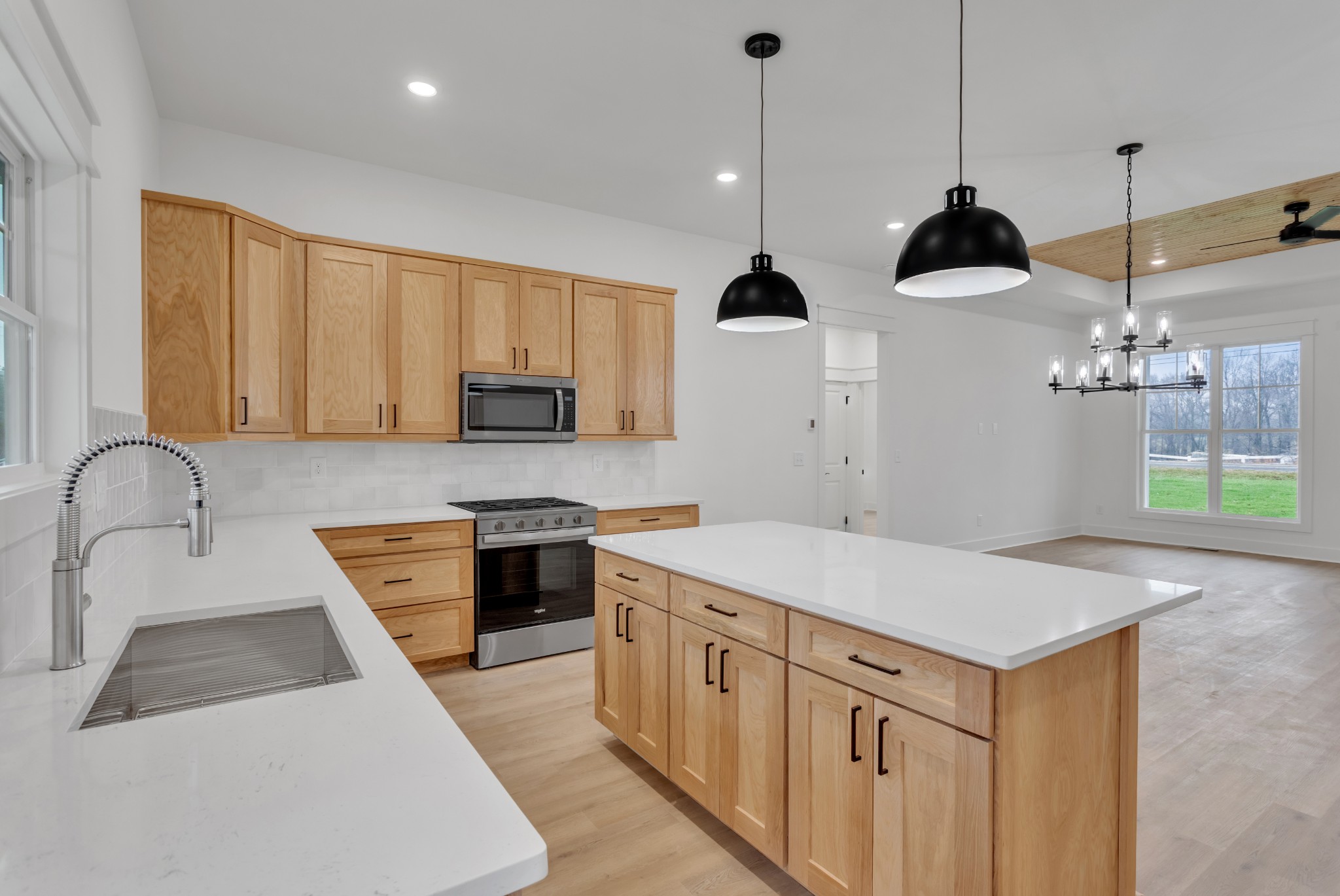 1111 Abiff Road Bon Aqua, TN 37025 - Photo 16 of 34 a kitchen with stainless steel appliances granite countertop a sink a stove a refrigerator and island with wooden floor