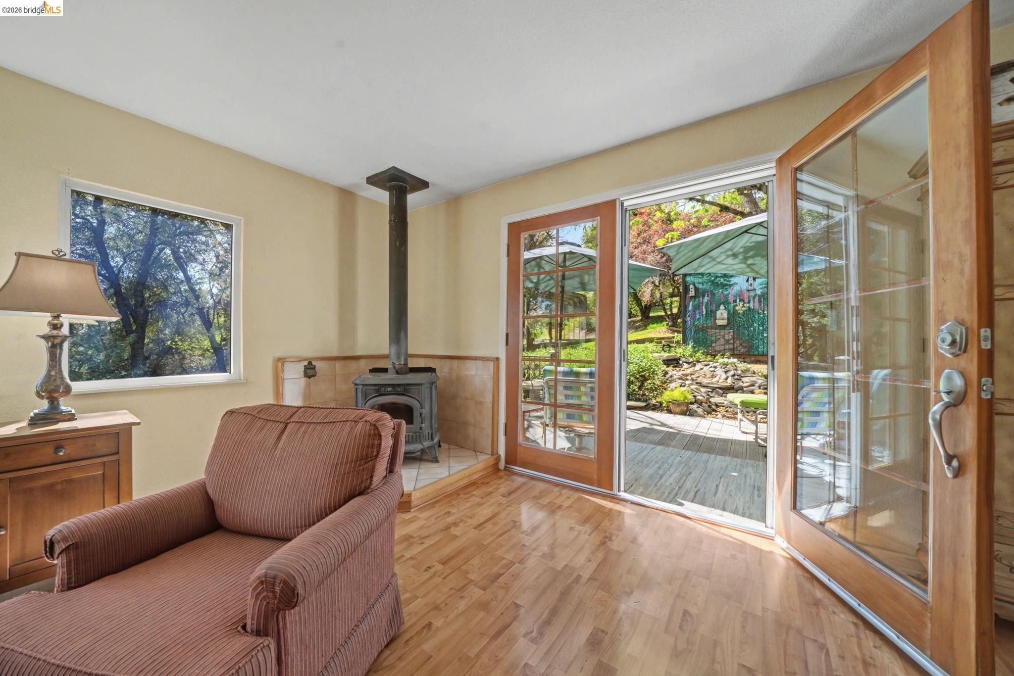 7035 Old Gulch Road San Andreas, CA 95249 - Photo 18 of 45 Living area with wood finished floors and a wood stove