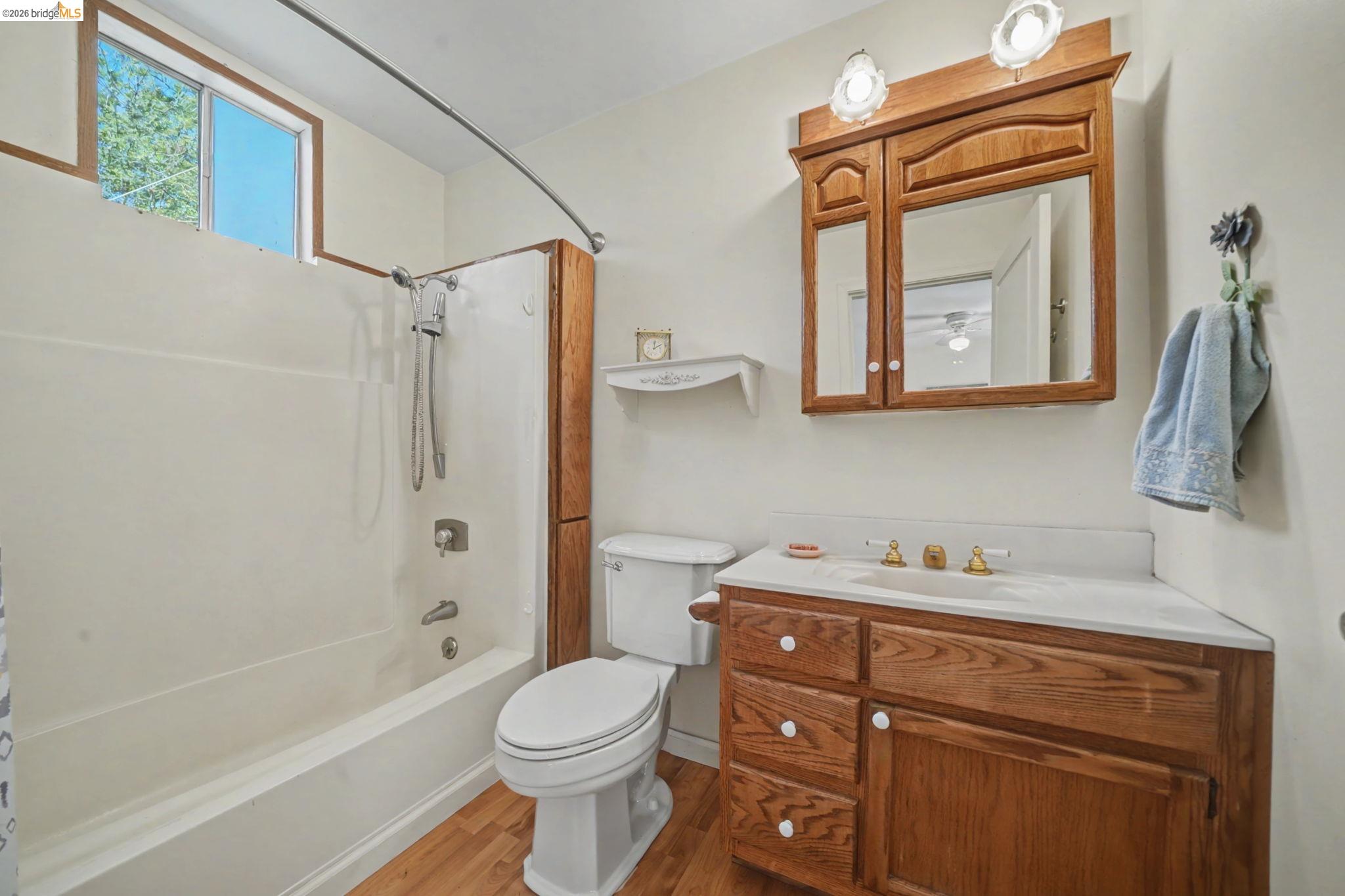 7035 Old Gulch Road San Andreas, CA 95249 - Photo 26 of 45 Bathroom with vanity, shower / tub combo, and light wood-type flooring