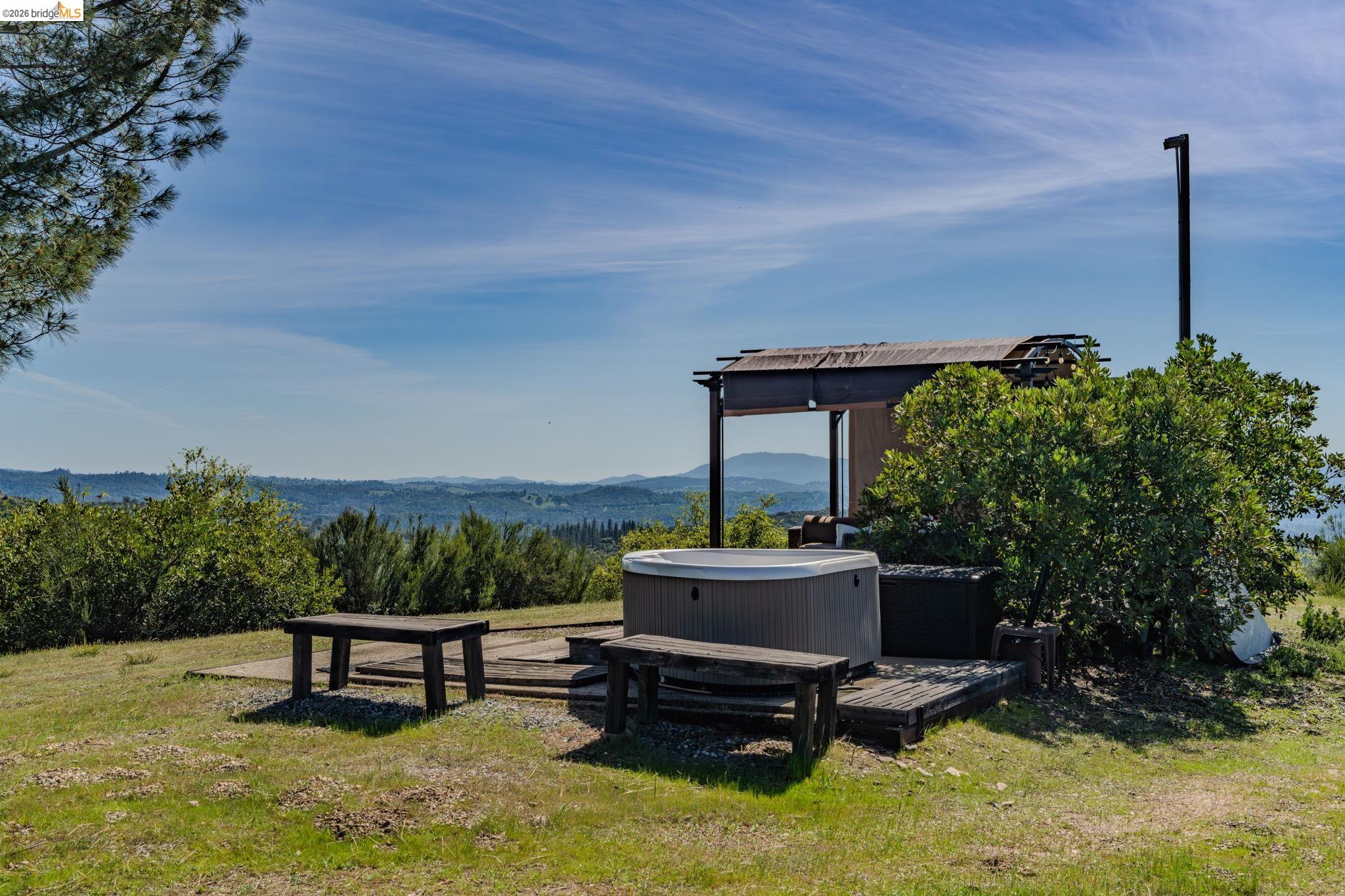 7035 Old Gulch Road San Andreas, CA 95249 - Photo 36 of 45 View of grassy yard featuring a mountain view and a hot tub