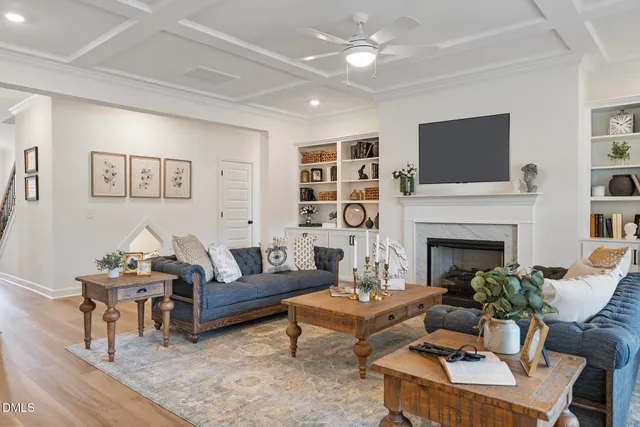 a living room with furniture a fireplace and a flat screen tv