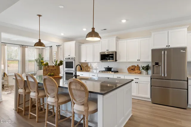 a kitchen with appliances a sink and a refrigerator
