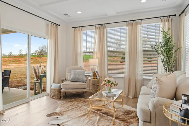 a living room with furniture and floor to ceiling windows