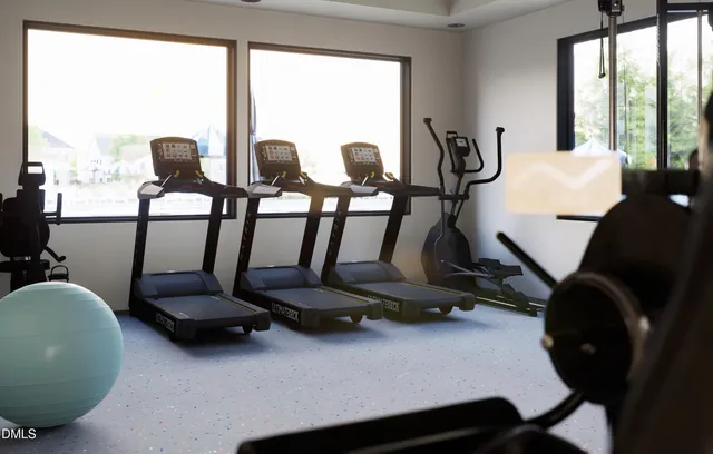 a room with gym equipment and a large window