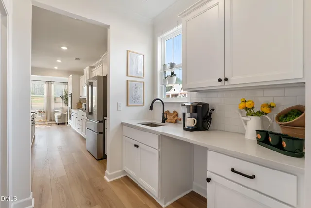 a kitchen with stainless steel appliances a refrigerator sink and cabinets