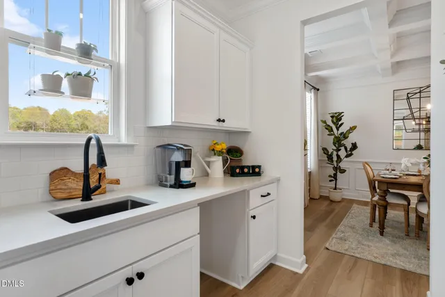 a kitchen with stainless steel appliances granite countertop a sink a stove and cabinets