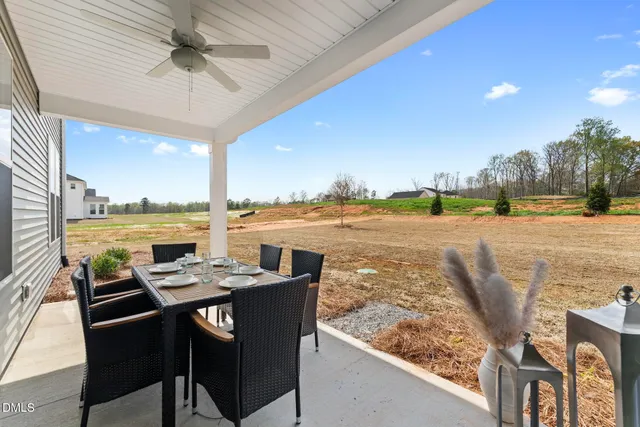 a view of a patio with a table and chairs