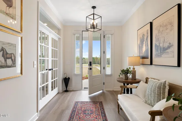 a living room with furniture and a chandelier
