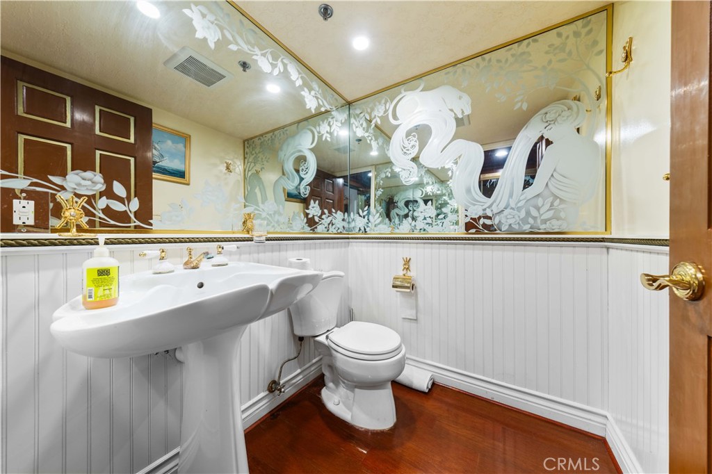 1782 Chota Road La Habra Heights, CA 90631 - Photo 49 of 74 a bathroom with a sink and mirror with toilet