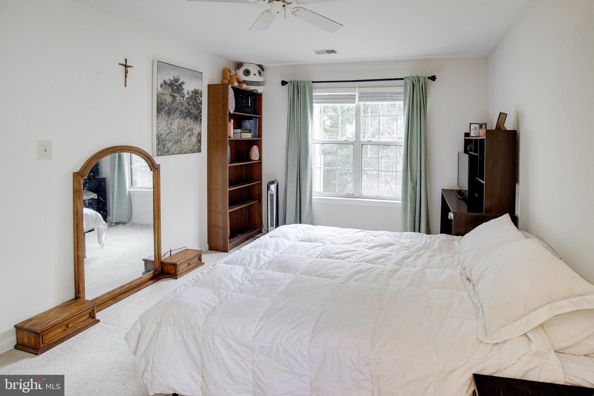 13615 Garfield Place, Unit 203 Woodbridge, VA 22191 - Photo 13 of 25 a bedroom with a bed and a large window
