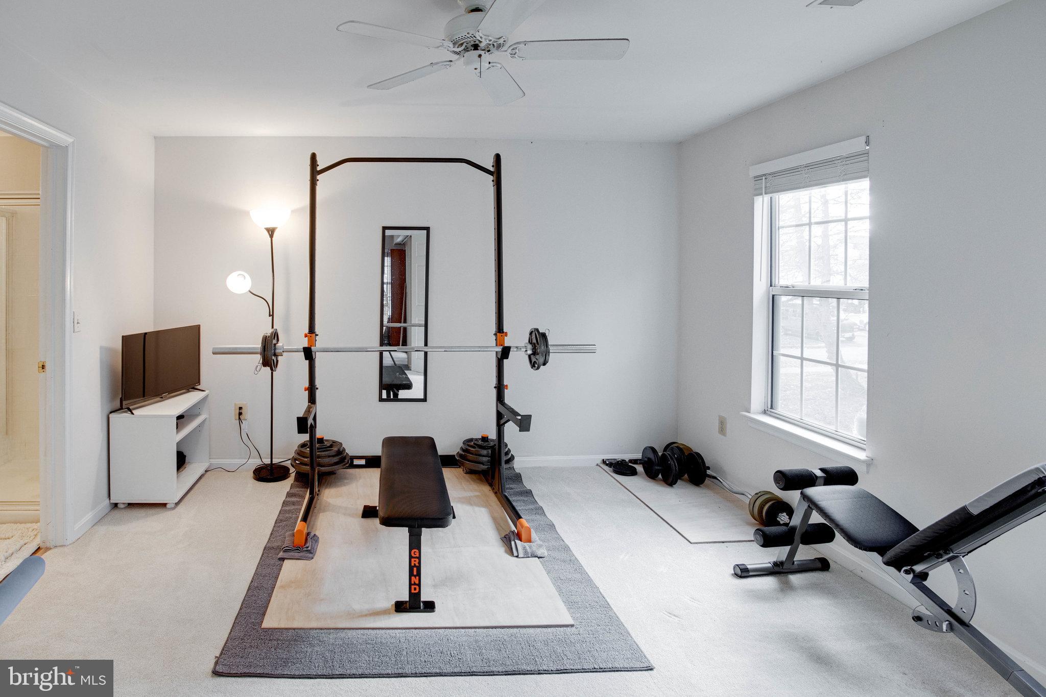 13615 Garfield Place, Unit 203 Woodbridge, VA 22191 - Photo 16 of 25 a room with gym equipment and a flat screen tv