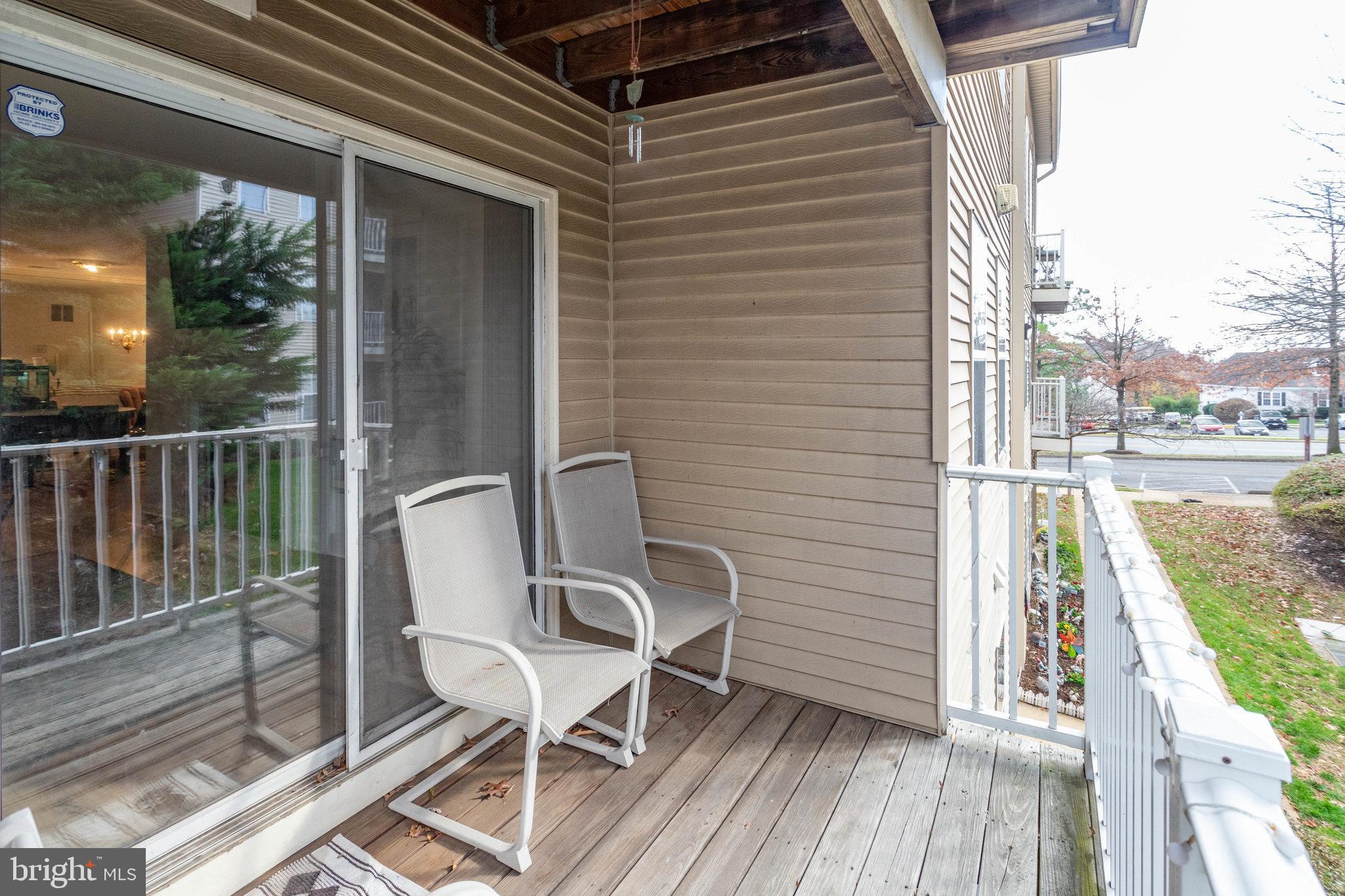 13615 Garfield Place, Unit 203 Woodbridge, VA 22191 - Photo 21 of 25 a view of a balcony with chair and wooden floor