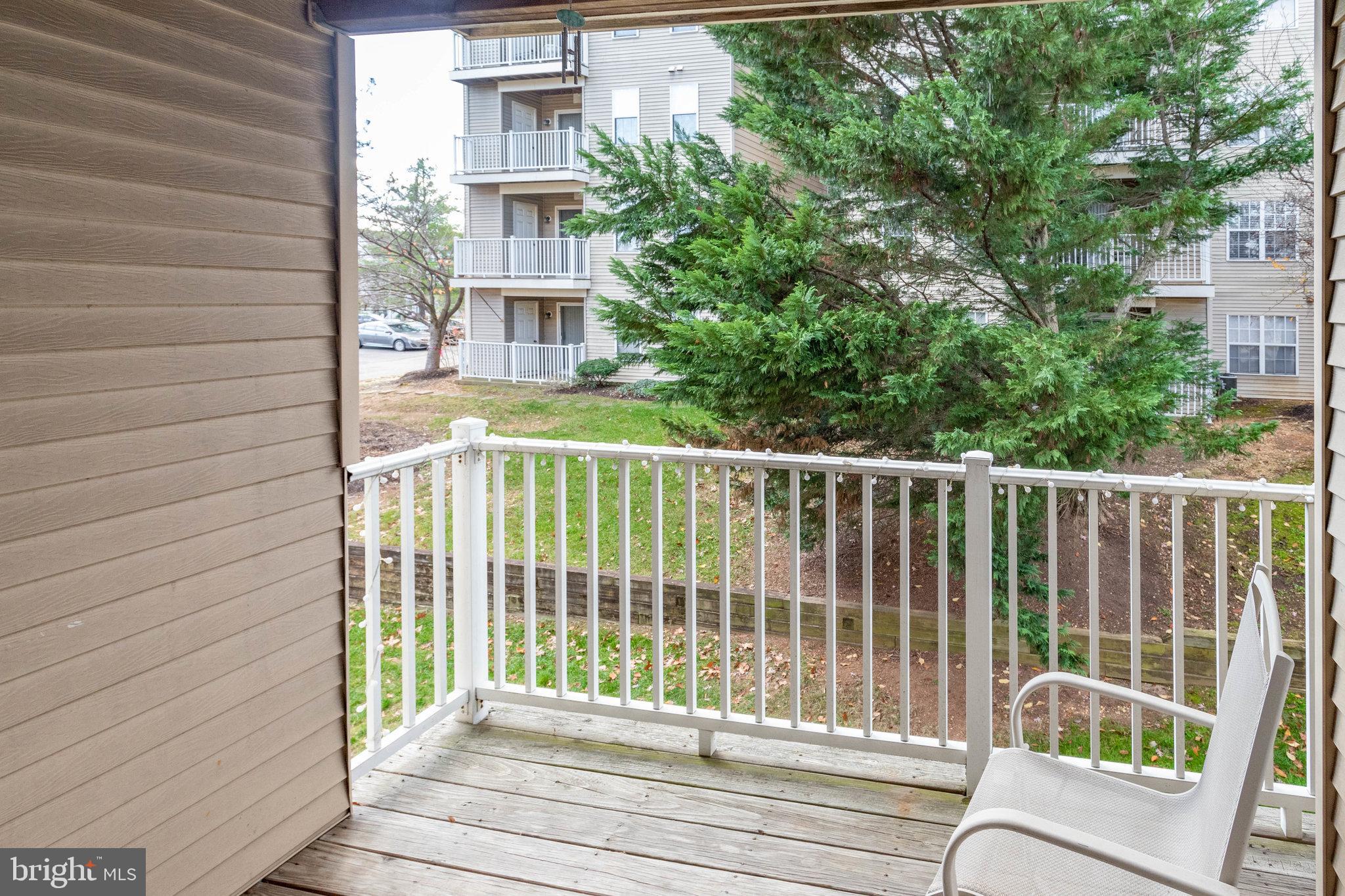 13615 Garfield Place, Unit 203 Woodbridge, VA 22191 - Photo 22 of 25 a view of a balcony with a floor to ceiling window and wooden fence