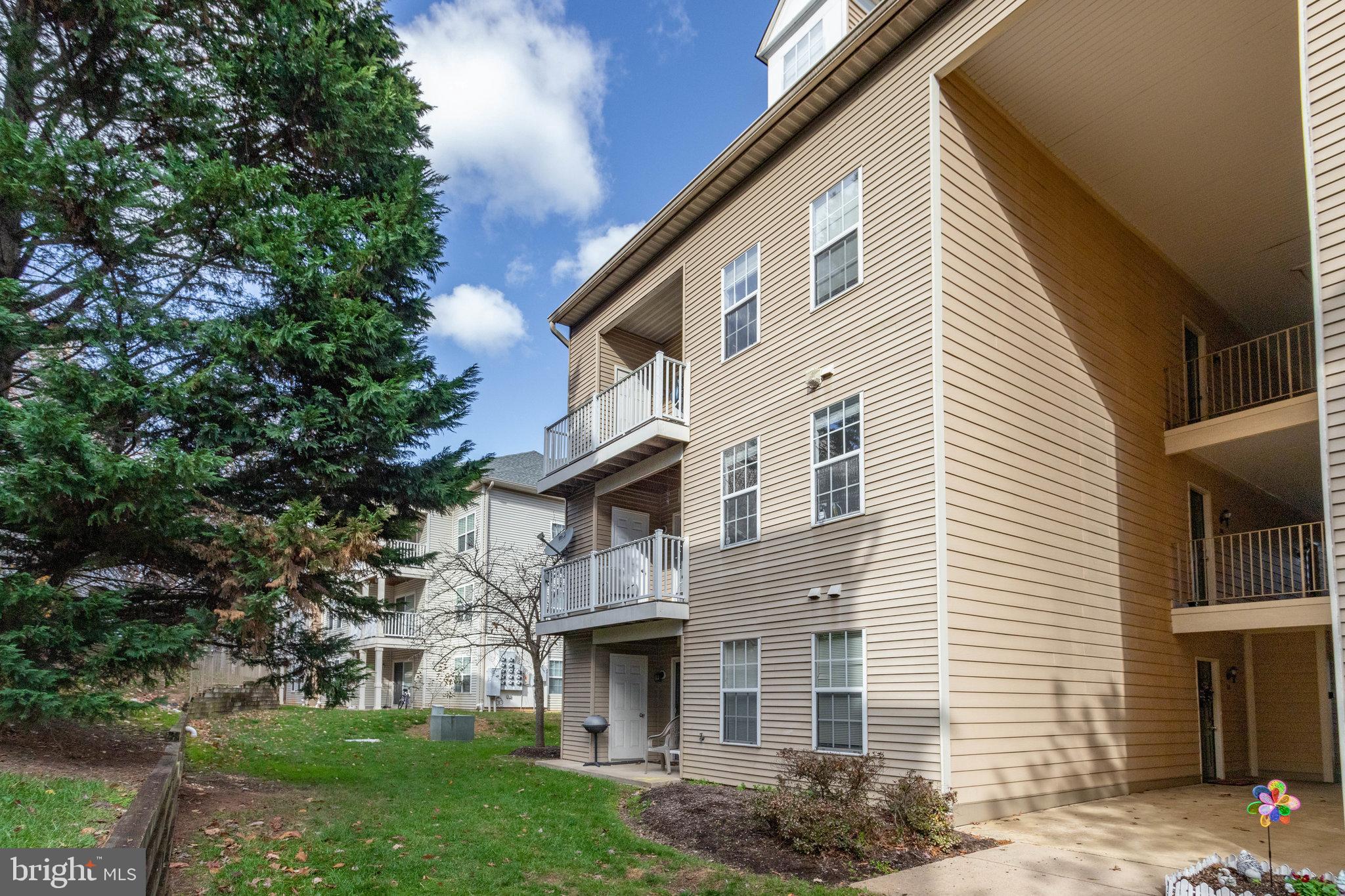 13615 Garfield Place, Unit 203 Woodbridge, VA 22191 - Photo 24 of 25 a front view of a house with garden