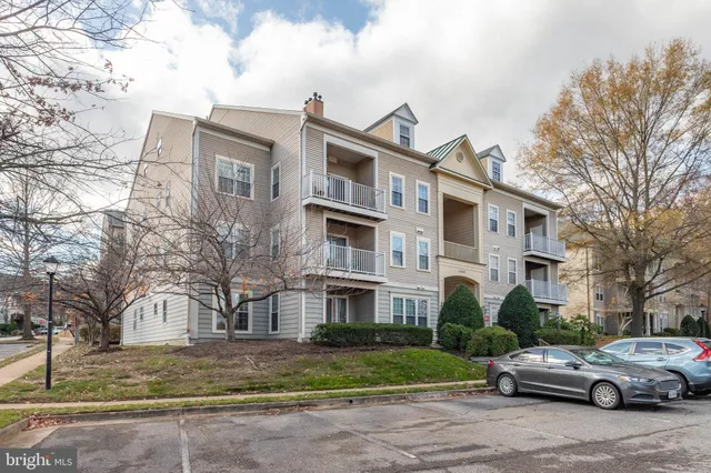 a front view of a residential apartment building with yard