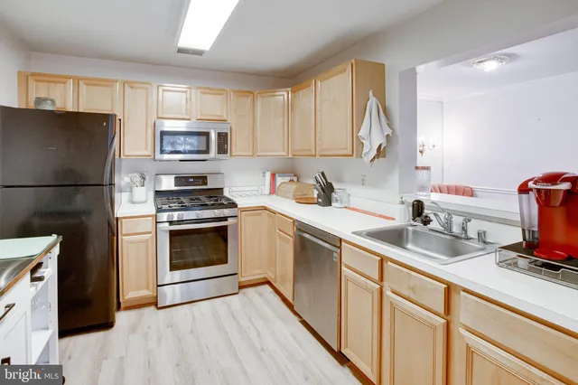 a kitchen with a sink stove and refrigerator
