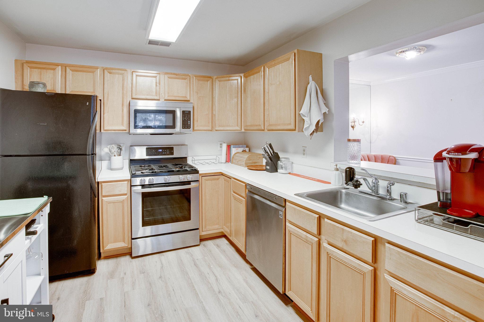 13615 Garfield Place, Unit 203 Woodbridge, VA 22191 - Photo 6 of 25 a kitchen with a sink stove and refrigerator