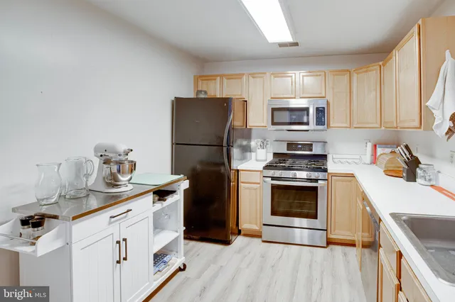 a kitchen with a sink a stove and refrigerator