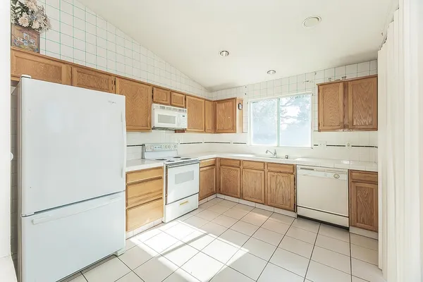 a kitchen with a white cabinets and white appliances