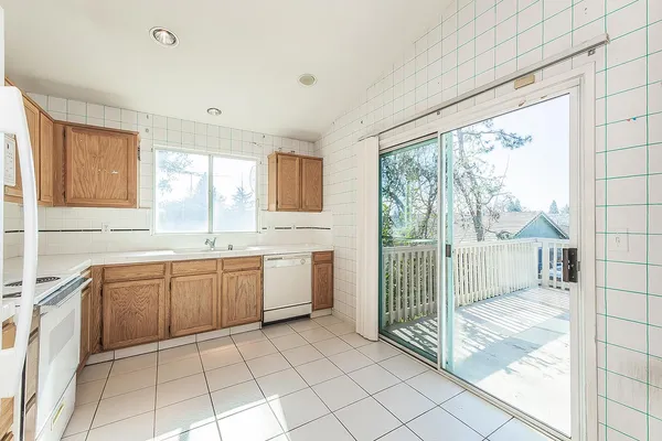 a kitchen with a sink window and cabinets
