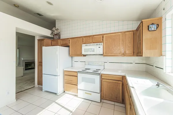 an empty room with windows and ceiling fan