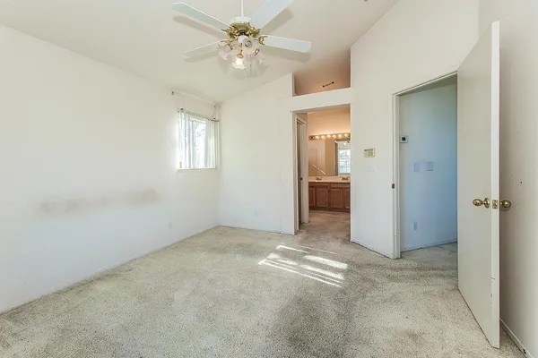 a spacious bathroom with a granite countertop sink and a mirror
