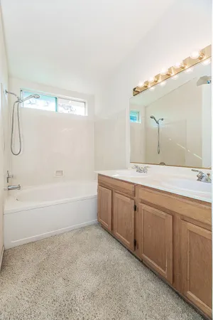 a bathroom with a sink a mirror and a shower