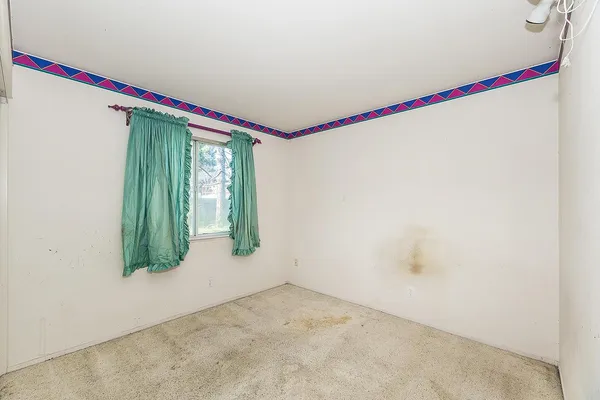 a very nice looking room with a big bed and a wooden floor