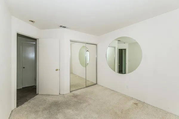 a view of a house with a balcony and wooden fence